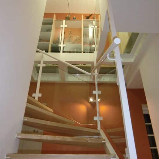 Escalier, plancher de verre et bibliothèque